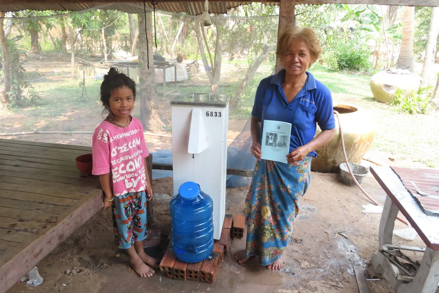 A grandmother and granddaughter with their biosand filter