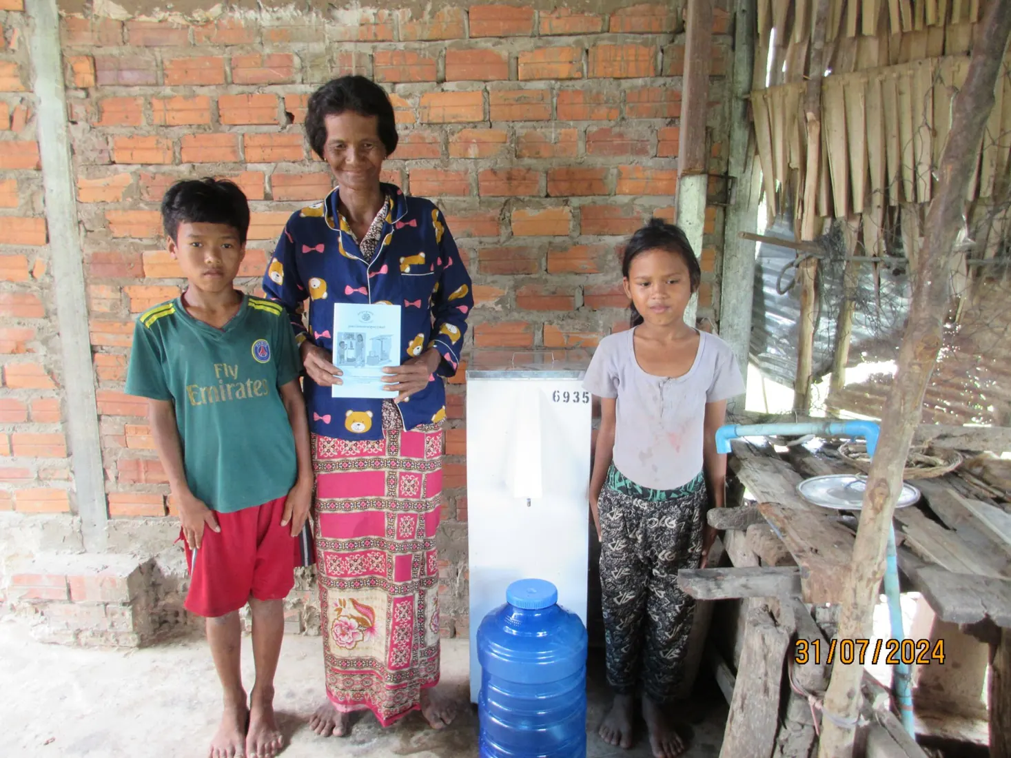 A Cambodian family stands beside their new biosand filter