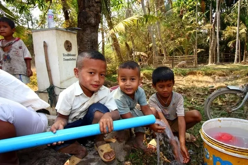 Children collect clean water in the village