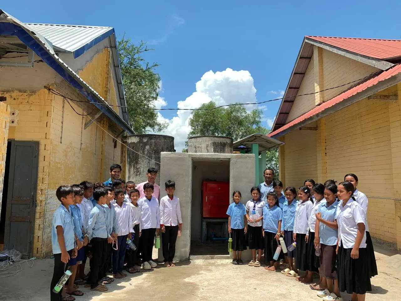 Students line up beside their school’s water system in rural Cambodia