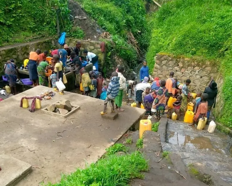 Families wait to collect water