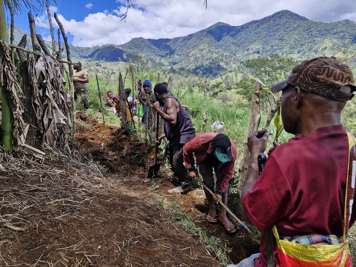 A Papua New Guinea community digging the trench for a new water line