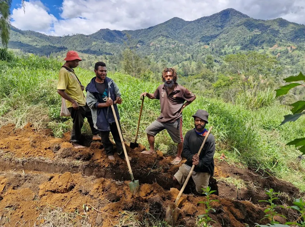 Community members dig the pipeline trench by hand