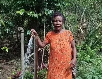 A tap stand near a family’s home