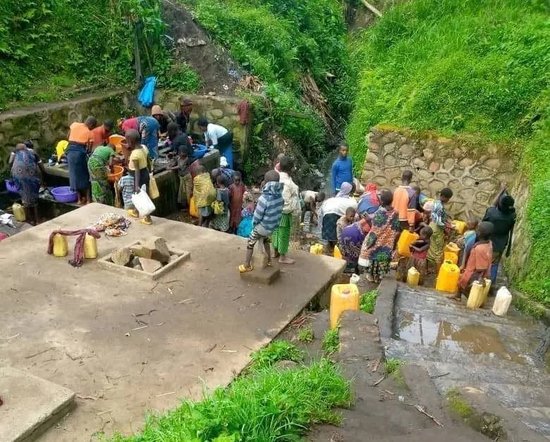 Families wait to collect water