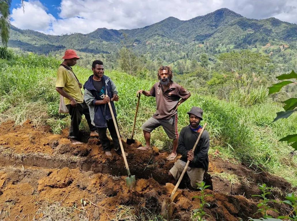 Community members dig the pipeline trench by hand